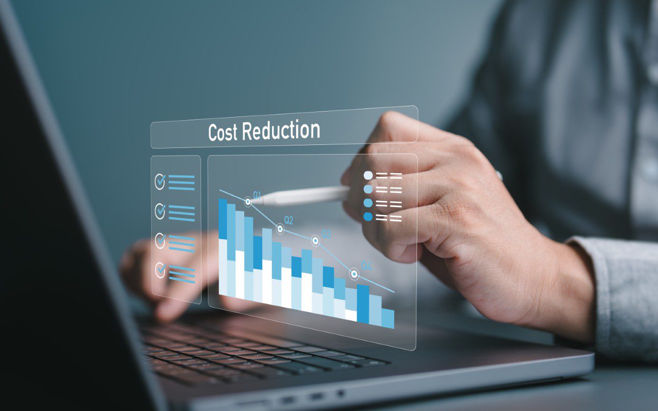 Man analyzing cost reduction graph on laptop.