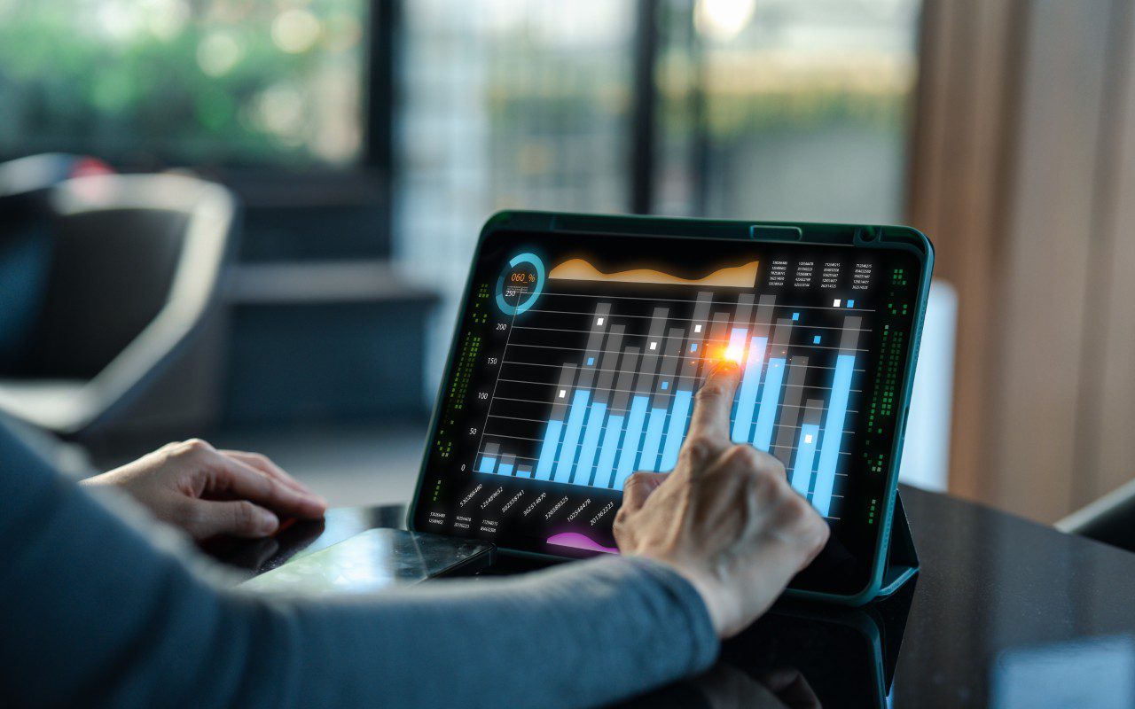 Person analyzing digital chart on tablet.