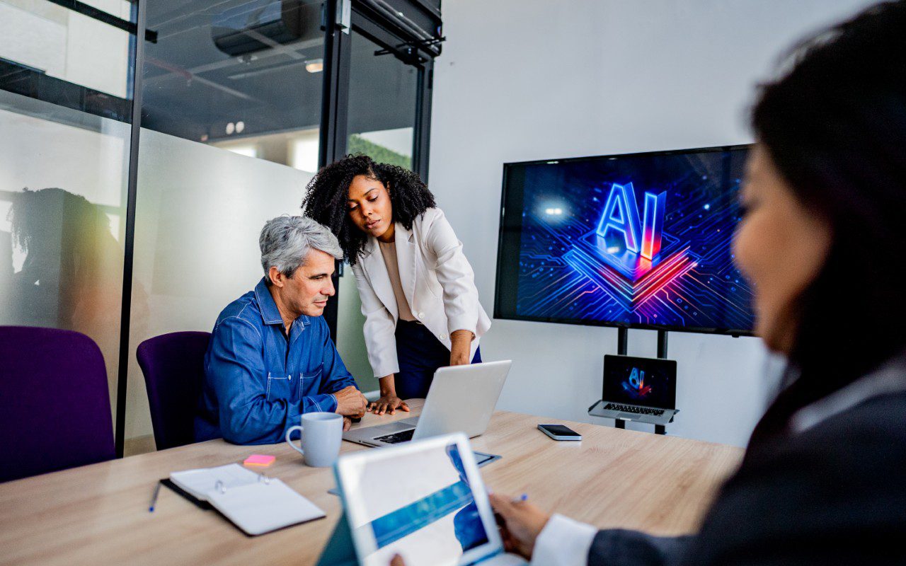 Business meeting discussing AI technology display.